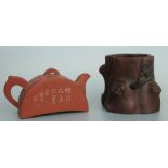 A Chinese Yixing pottery teapot, 9ccms high; together with a similar stump form planter with