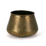 An Islamic brass palm pot decorated with foliate scrolls and calligraphy, 19cms high.