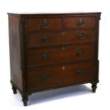 An early 19th century oak chest with two short and three graduated long drawers, on turned feet,