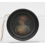 A Victorian wax portrait miniature depicting a young lady in an ebonised frame, 9cms diameter.