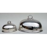 A large silver plated meat dome, 49cms wide; together with a similar smaller, 30cms wide (2).