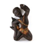 A South East Asian carved wooden figure of a dance with applied mirror decoration, 31cms high.