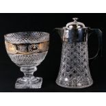 A cut glass water jug with silver plated mounts, 26cms high; together with a glass pedestal bowl