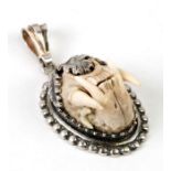 A Charivari German huntsman pendant with a full set of pole cat teeth, marked 925 silver, 3cms
