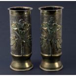 A pair of WWI trench art shell cases decorated with flowers, 23cms high.