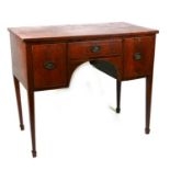 An Edwardian mahogany side table with central frieze drawer flanked by cupboards, on square tapering