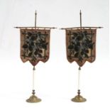 A pair of Victorian beadwork table screens depicting floral scenes, on gilt metal stands, 23cms high