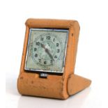 An Art Deco leather cased travel clock, 5 by 7cms.