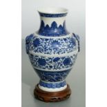 A Chinese blue & white vase with elephant mask handles, decorated with foliate scrolls and waves,