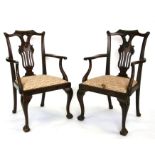 A pair of 19th century style mahogany elbow chairs with pierced back splats, upholstered drop-in