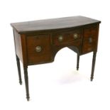 A Regency mahogany bowfronted sideboard with central frieze drawer flanked by cupboards, on ring