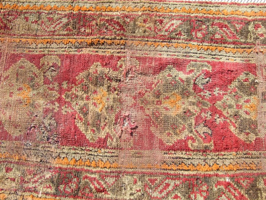 A Turkish runner with repeated floral decoration on a red ground, 392 by 73cms. - Image 5 of 6