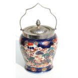 A pottery biscuit barrel with silver plated mounts decorated in the Imari palate, 21cms high.