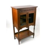 An Edwardian walnut display cabinet, the pair of glazed doors enclosing a shelved interior with
