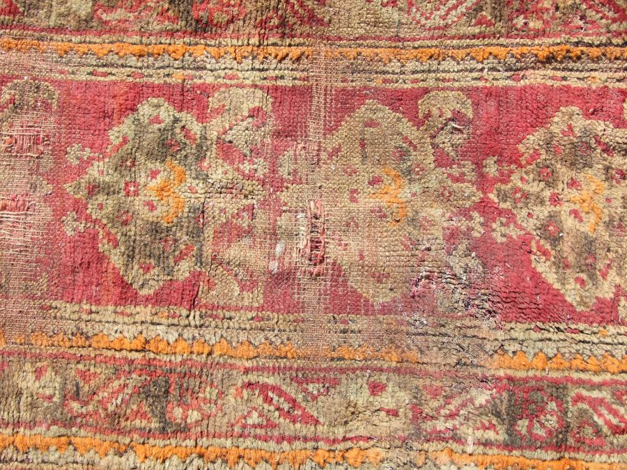 A Turkish runner with repeated floral decoration on a red ground, 392 by 73cms. - Image 6 of 6