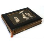 An early 20th century Japanese photograph album with shibayama panel decorated with figures, 35cms