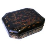 A Chinese lacquered games box decorated with birds and flowering foliage on a black ground with