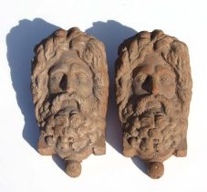 A pair of large terracotta wall pockets in the form of a bearded man, 44cms high (2).