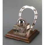 Equestrian interest. A silver plated desk stand with horse shoe pen rest and cut glass inkwell