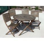 A set of four teak folding garden chairs & matching table (5).