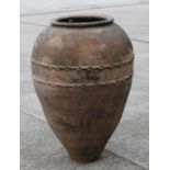 A large terracotta olive jar of tapering cylindrical form with scalloped band decoration, approx