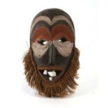 An African mask with painted decoration, 35cms high.