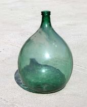 A large Victorian green glass carboy, 63cms high.