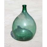 A large Victorian green glass carboy, 63cms high.