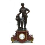 A large late 19th century bronzed spelter and marbled figural mantle clock with a surmounted