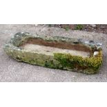 A well weathered carved stone trough, 88 by 33cms.