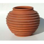 A terracotta planter of ribbed form, 33cms high.