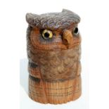 A 1920's carved Black Forest / Swiss humidor in the form of an owl with glaass eyes, 15cms high.