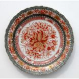 An 18th century Chinese Rouge de Fer scalloped edged plate with lotus flower centre within a black