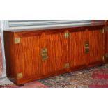 A Chinese hardwood side cabinet with two pairs of cupboard doors enclosing a shelved interior,