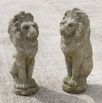 A pair of reconstituted stone rampant lions. 51cm high