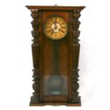 A Vienna style wall clock in a walnut case, 44cms wide.