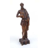 A carved wooden figure depicting Don Quixote, 56cms (22ins) high.