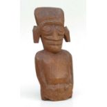 An Easter Island style carved wooden figure, 33cms high.