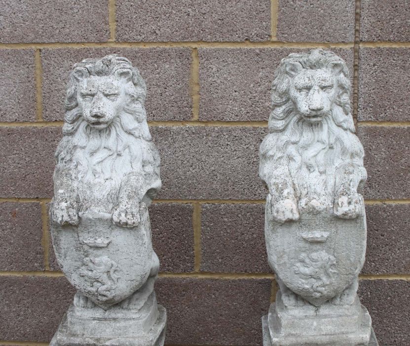 A pair of reconstituted stone rampant lions on square plinths, overall 115cms high. - Image 2 of 3