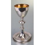 A white metal challis with gilded interior and knopped stem. 21cm high. 398g