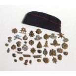 A quantity of military cap badges and buttons to include Glamorgan, Royal Army Services Corp, Fear