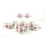 A Portuguese Vista Alegre ten-place coffee set hand p[painted with puce with town scenes.