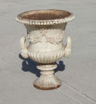A large Victorian white painted cast iron two-handle Campana vase decorated with fruit swags,