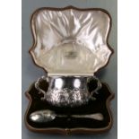 A Goldsmiths & Silversmiths cased silver two-handled sugar bowl and matching spoon with acanthus