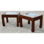 A pair of Chinese hardwood coffee tables with inset glass tops and brass corners, 61 by 61cms (2).