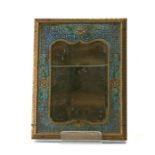 A Chinese champlevé / cloisonne mirror frame with ornate embossed gilt border, overall 24 by 32cms.