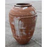 A terracotta olive jar with impressed decoration, approx 70cms high.