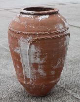 A terracotta olive jar with impressed decoration, approx 70cms high.