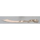 A Sterling silver letter opener with scrolling flower handle. 23cm long