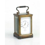 A miniature brass cased carriage timepiece, the white enamel dial with Roman numerals and marked '